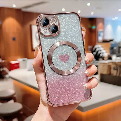 a woman holding up a pink glitter iphone case