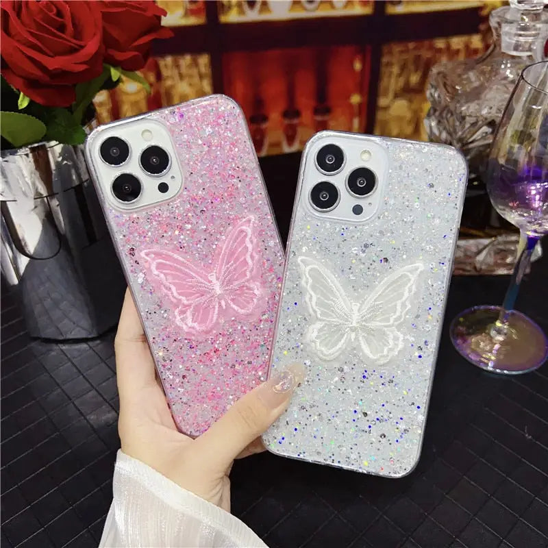 a woman holding a pink glitter phone case