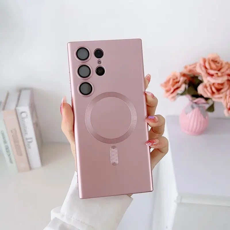 a woman holding up a pink phone case