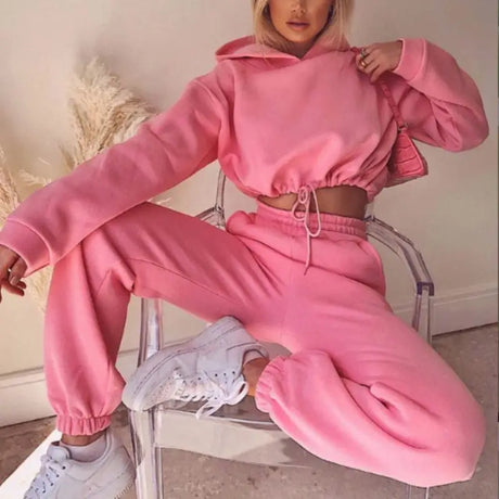a woman in pink sweat suit sitting on a chair