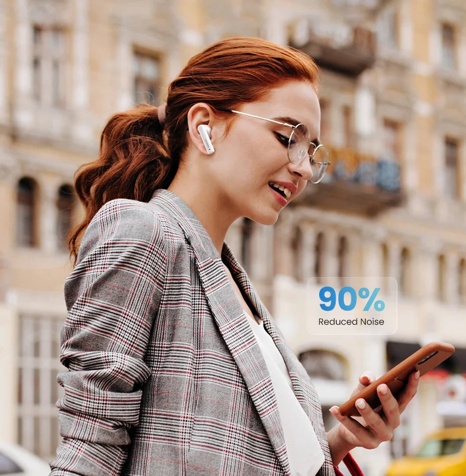 Woman wearing a plaid blazer and glasses using a smartphone while wearing wireless earbuds.