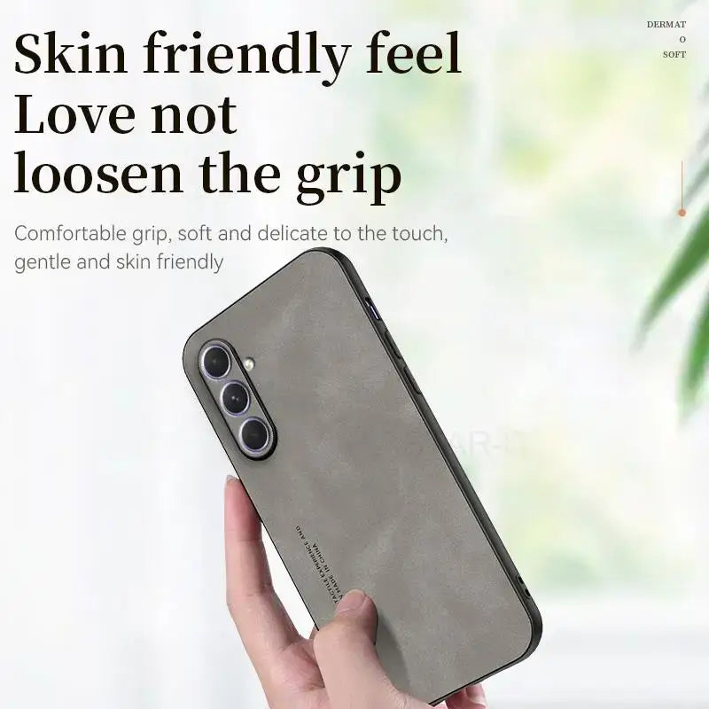 The back of a woman’s hand holding a gray iphone case