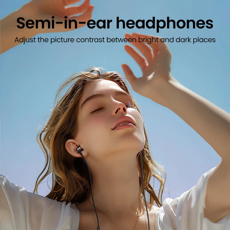 Woman wearing semi-in-ear headphones with her face tilted upward and arms raised.
