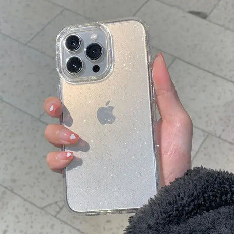 a woman holding a silver iphone case