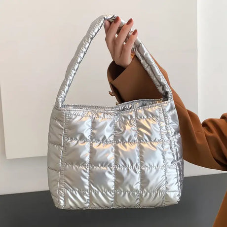 a woman holding a silver purse