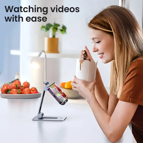 A woman sitting at a table with a cup and a cell