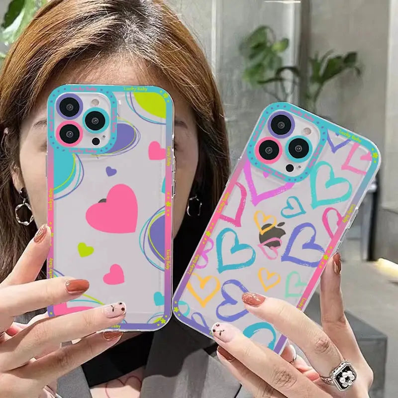 A woman holding up two colorful phone cases