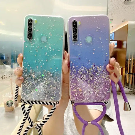 a woman holding up two phone cases with glitter stars on them