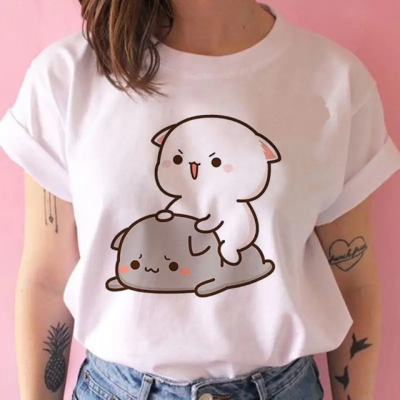 a woman wearing a white t shirt with a cat on it