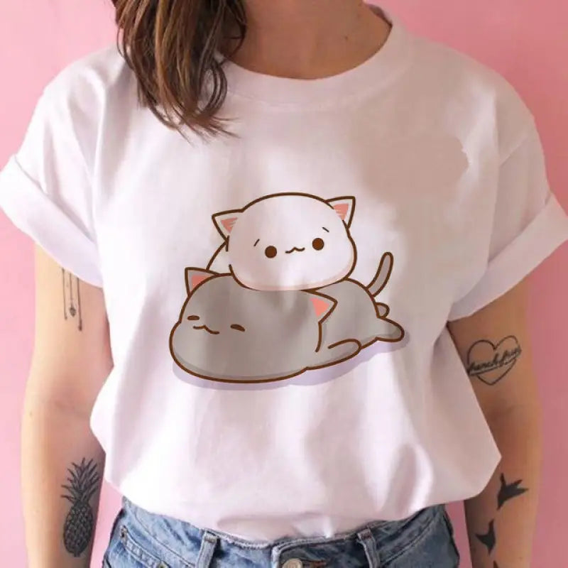 a woman wearing a white t shirt with a cat on it