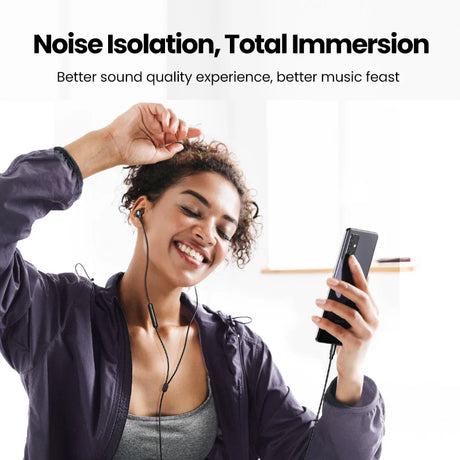 Woman using wired earphones with smartphone.