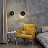 a yellow chair in front of a grey wall