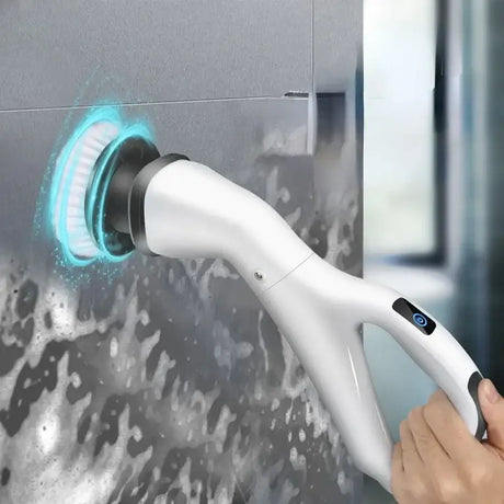 a person using a handheld hand held to clean a shower