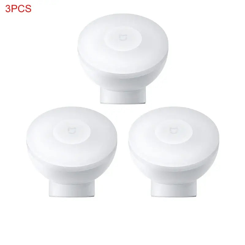 three white knobs with a white cover on a white background
