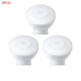 three white knobs with a white cover on a white background