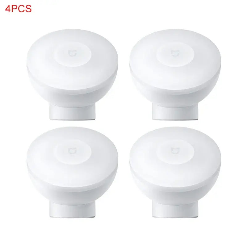 four white knobs with a white cover on a white background
