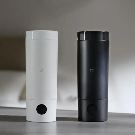 two different types of air purifiers are on a table