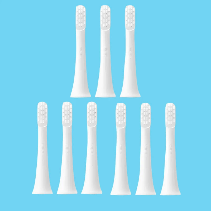 six white toothbrushes with white bristles on a white background