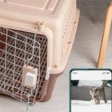 a cat is sitting in a cage next to a phone