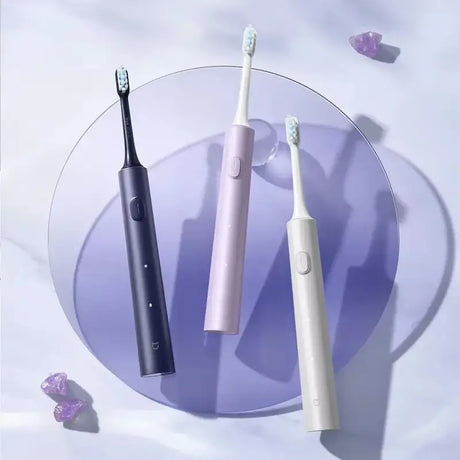 a white and black toothbrush on a purple plate