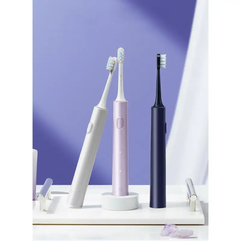 there are two toothbrushes sitting on a shelf next to a toothbrush holder