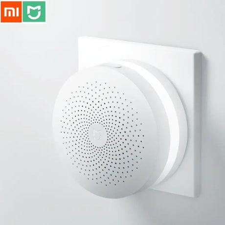 a close up of a white smart device mounted on a wall