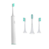 three electric toothbrushes with different colors and shapes on a white background