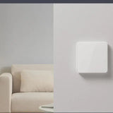 a white wall mounted light switch on a wall