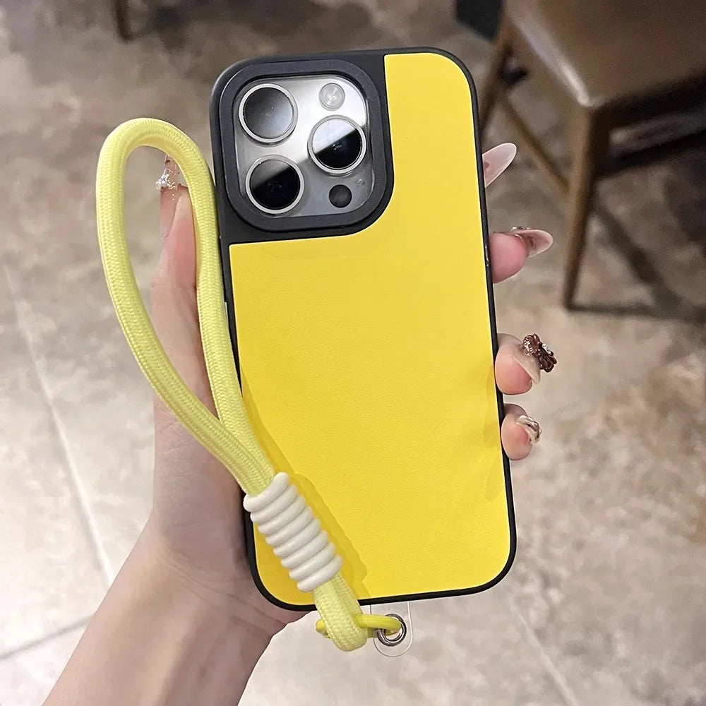 Yellow and black phone case with wrist strap.
