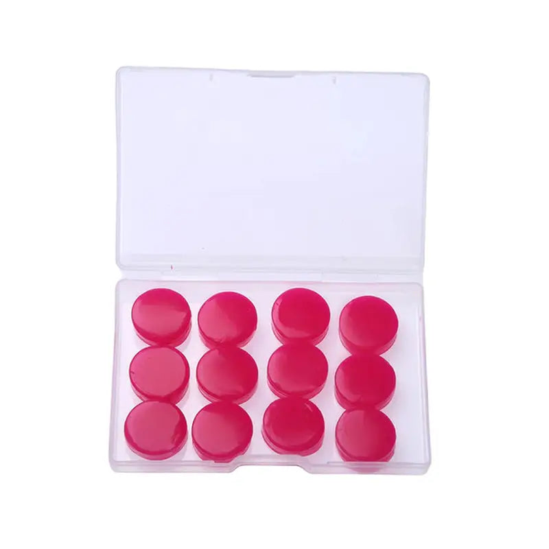 a set of red plastic buttons in a clear case