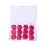 a set of red plastic buttons in a clear case