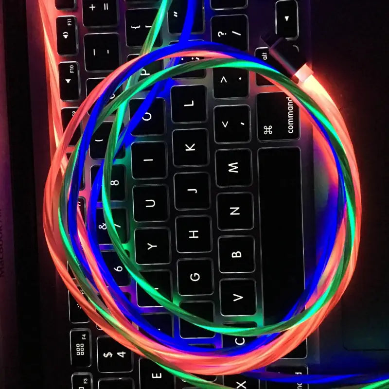 a computer keyboard with a glowing neon colored neon on it