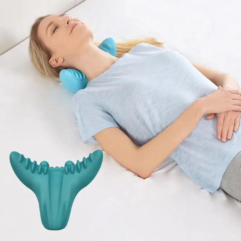 a woman laying on the floor with her back in a cervical pillow