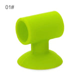 a green plastic cup holder with a white background