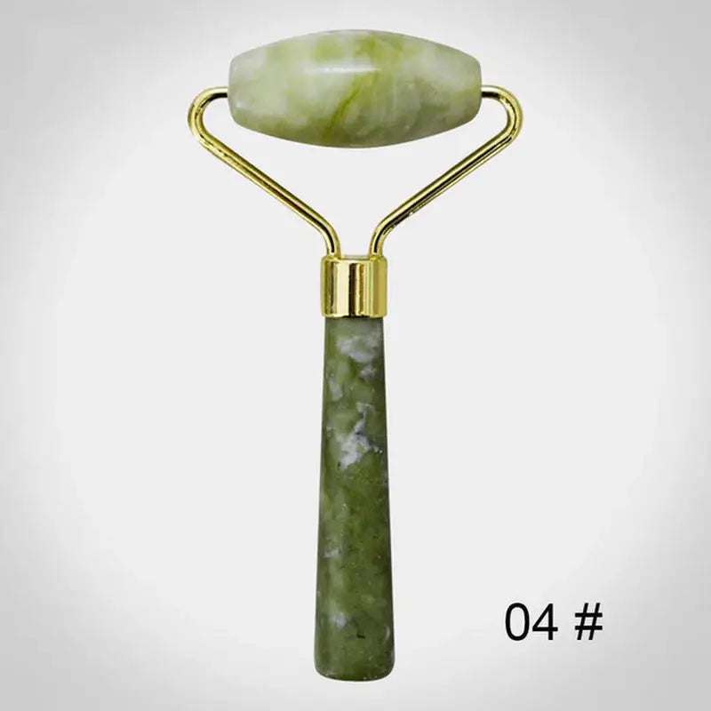 a green jade roller with a gold handle