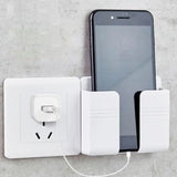 a white charging station with a phone and a white charger