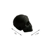 a black skull head with a white background
