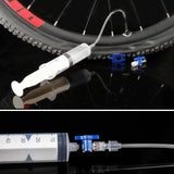 a close up of a bicycle tire with a tube and a needle