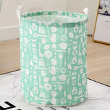 a green and white laundry basket with a pattern of kitchen uts