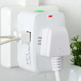 there is a white plugged in wall charger with a green button