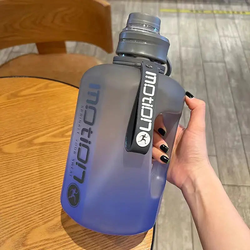 a person holding a water bottle on a table