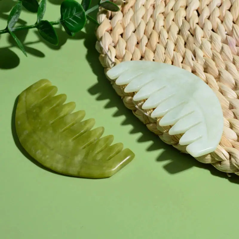 a green jade stone next to a white jade jade