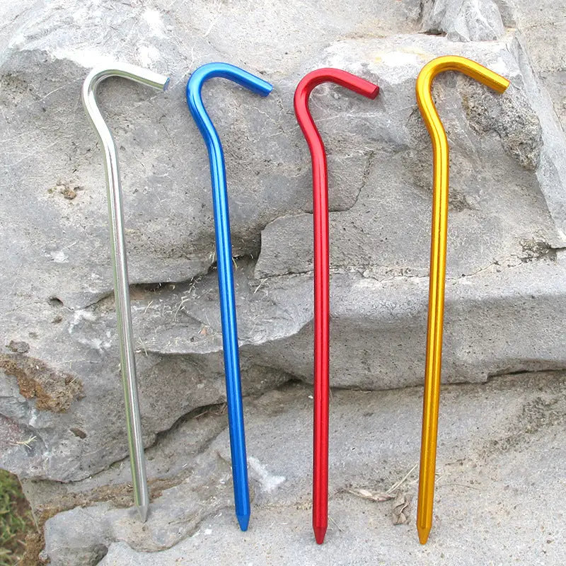 three different colored metal walking canes sitting on a rock