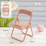 a pink plastic folding chair with a small pig