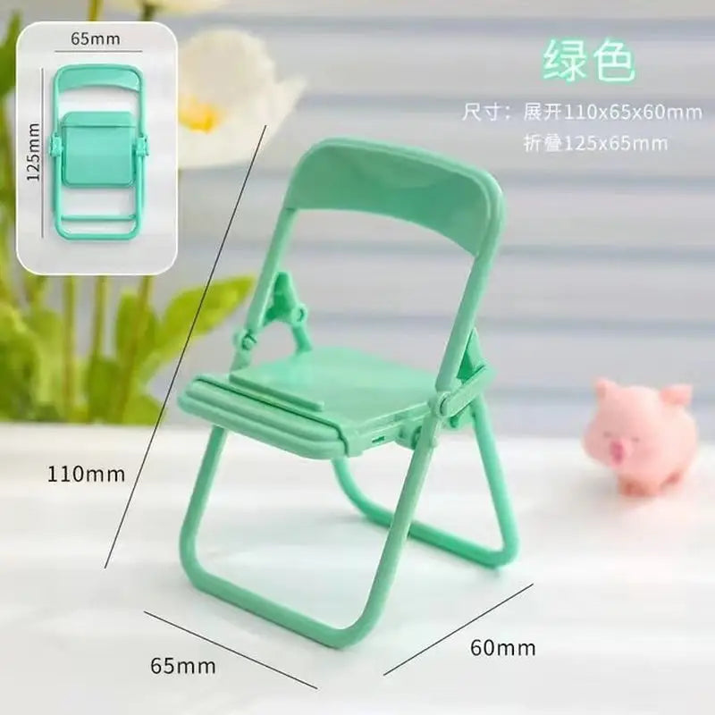 a green plastic folding chair with a small pig