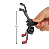 a hand holding a black and red bike handle