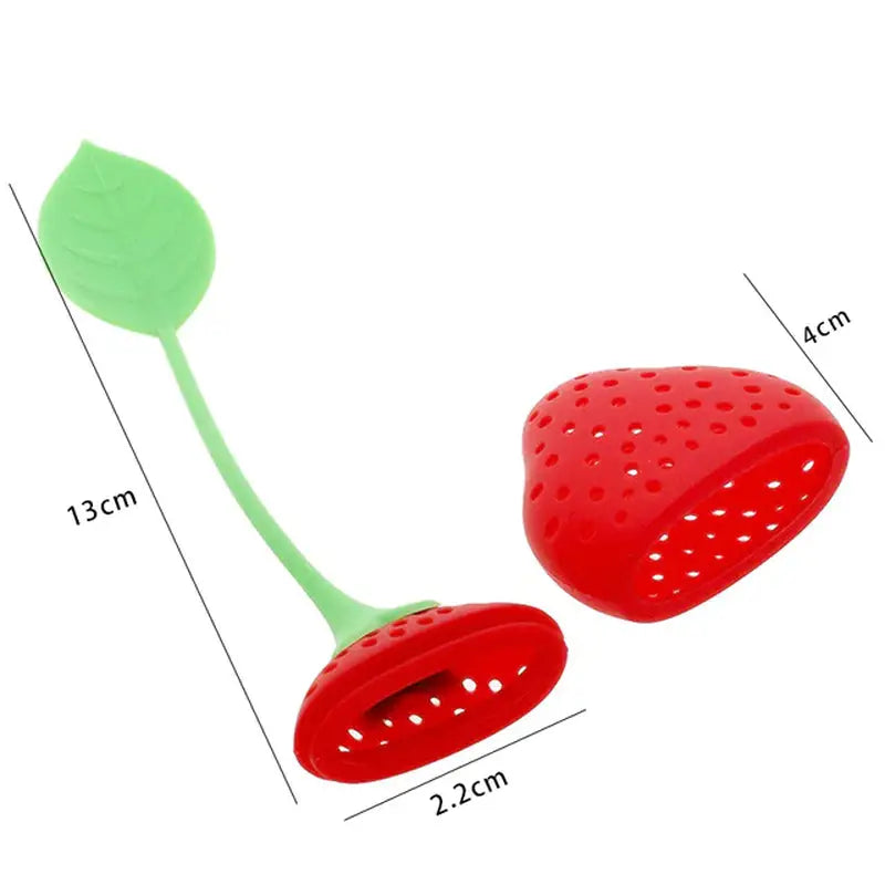a strawberry shaped plastic spoon with a green handle