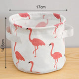 a white fabric storage bag with pink flamings on it