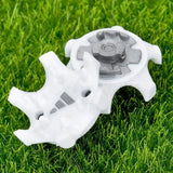 a white plastic toy on a green grass