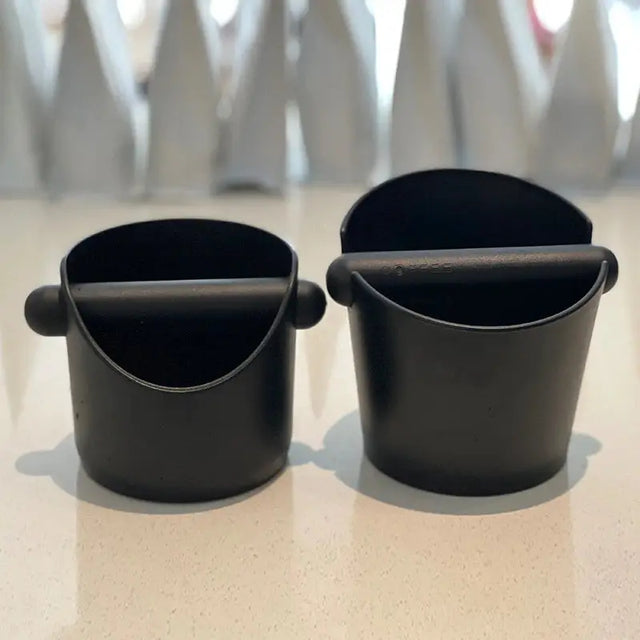 two black cups sitting on top of a counter